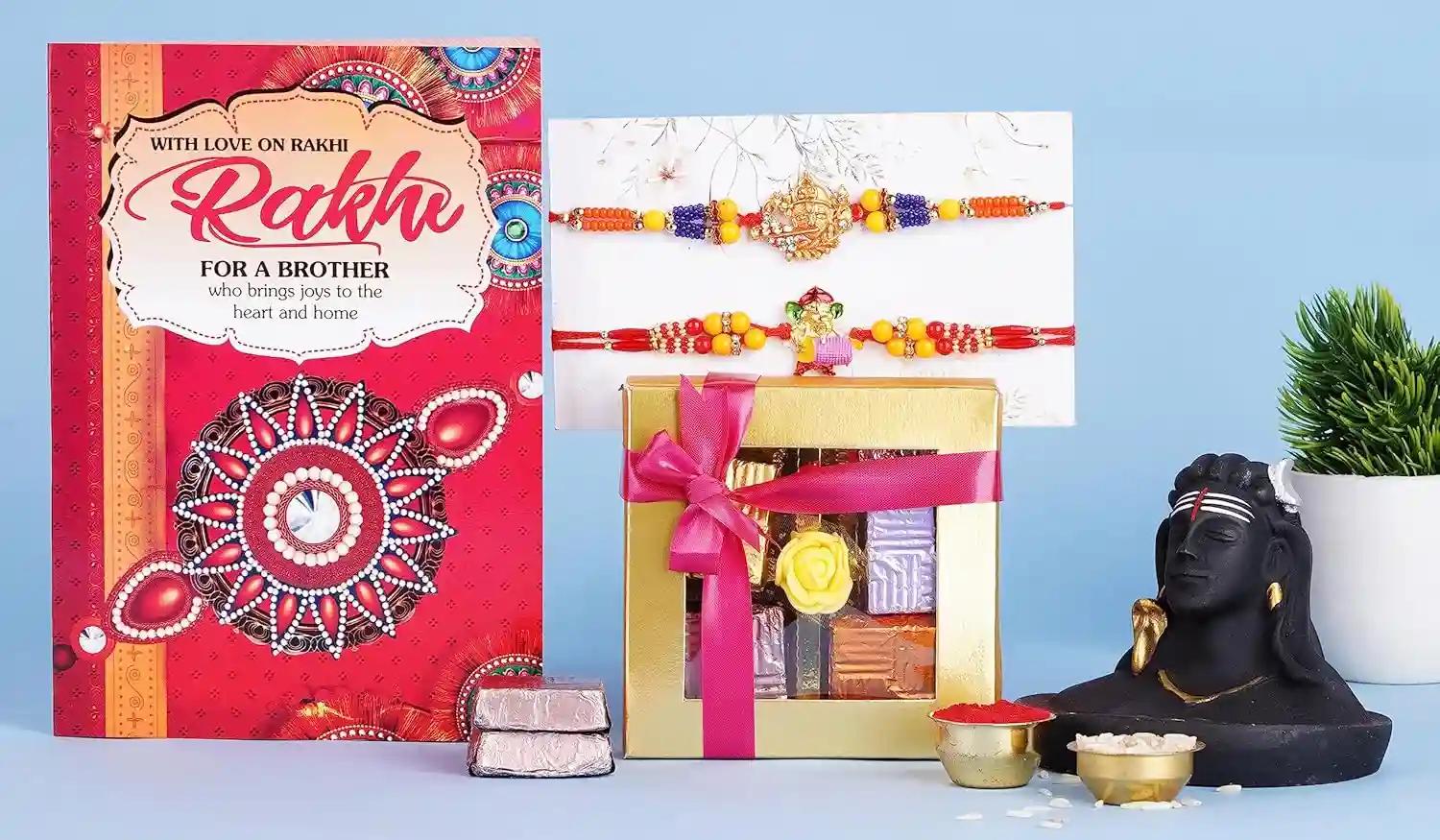 Rakhi/Rakhi For Brother/Rakhi Gift For Brother/Rakhi For Brother And Bhabhi/Rakhi For Brother With Gift-2 Gold Plated Rakhi+Showpiece Figurine+Roli Chawal Packet+Rakhi Greeting Card